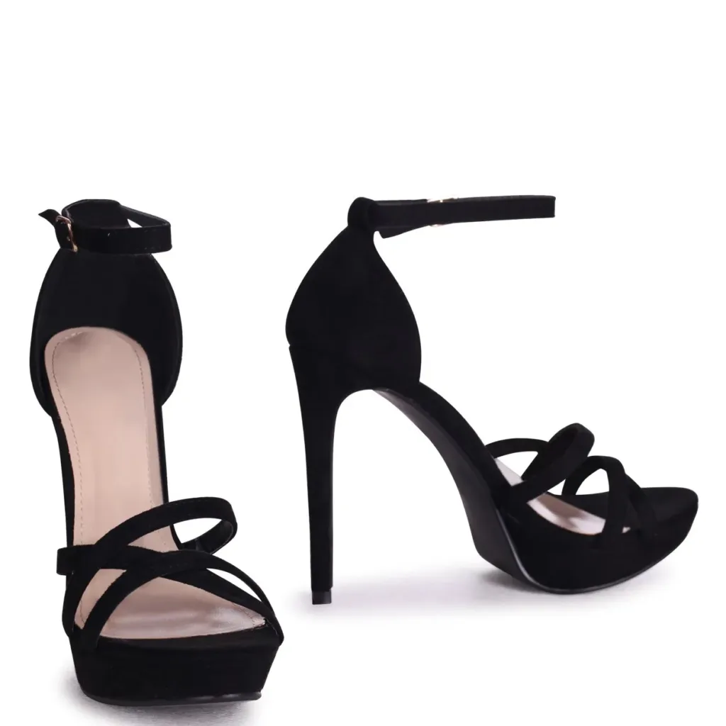 Black platform heels by Lajwanti Shoes with ankle strap and crisscross design.