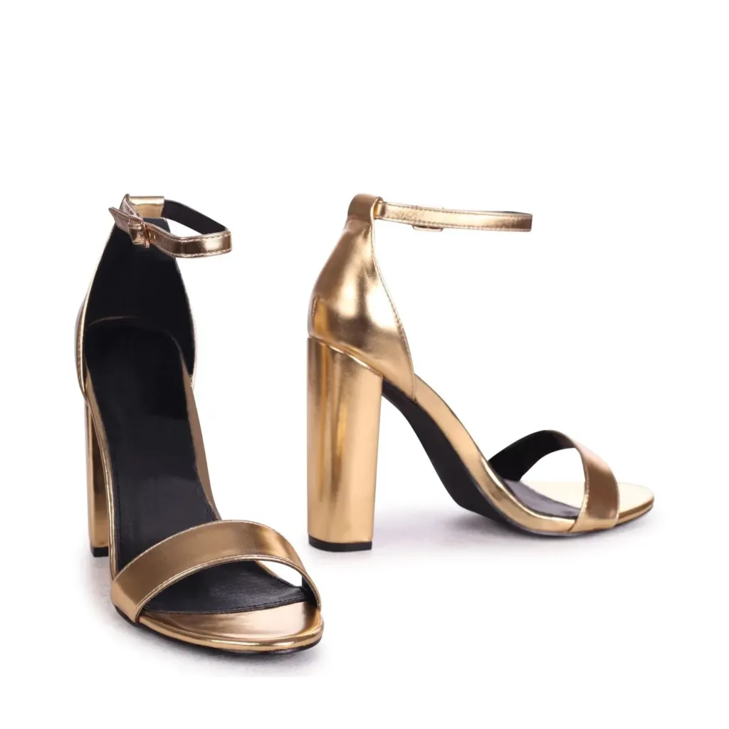 Gold heels for women by Lajwanti Shoes with ankle strap and block heel design.